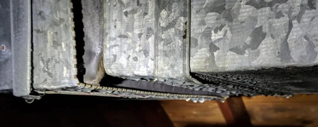 Condensation forming on HVAC equipment caused by hot air meeting cold surfaces, resulting in mold risks